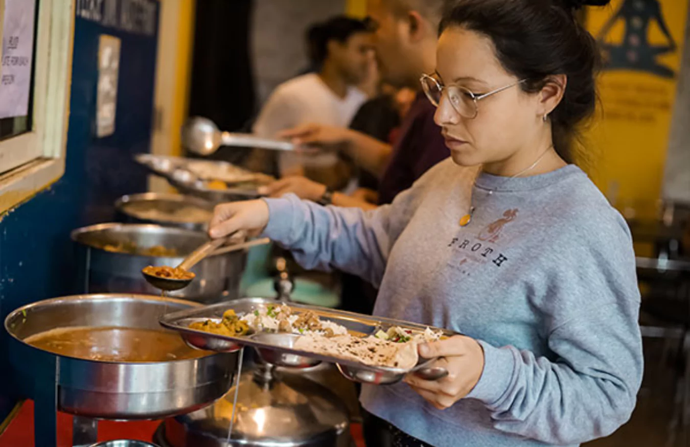 Students enjoying a community meal at Anagha Yoga School.