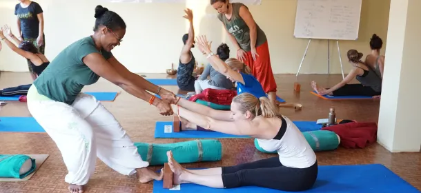 A teacher and student in a traditional yoga learning environment.
